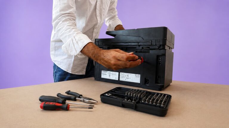 Technician repairing HP laser printer rear panel, Print Legend Madurai